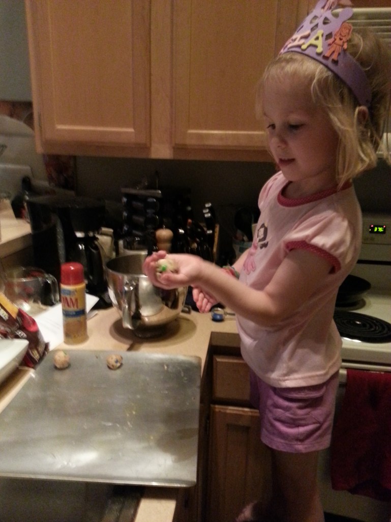 carefully shaping the dough into balls