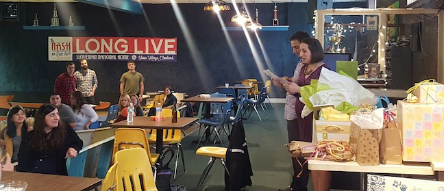 Mom- and dad-to-be giving a speech at the shower - bowling in the background!