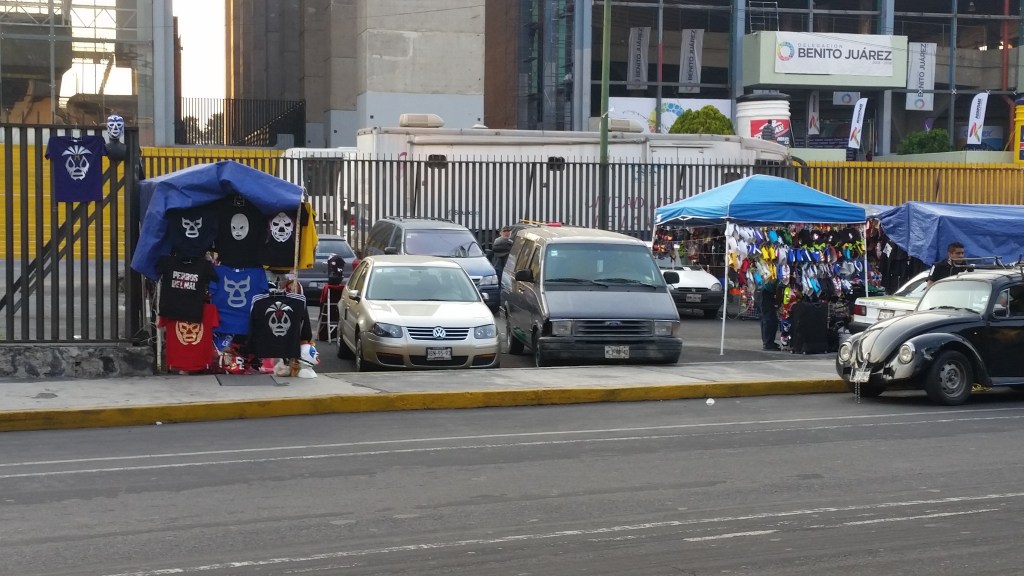 before the fight, vendors sell masks, snacks, shirts, etc.